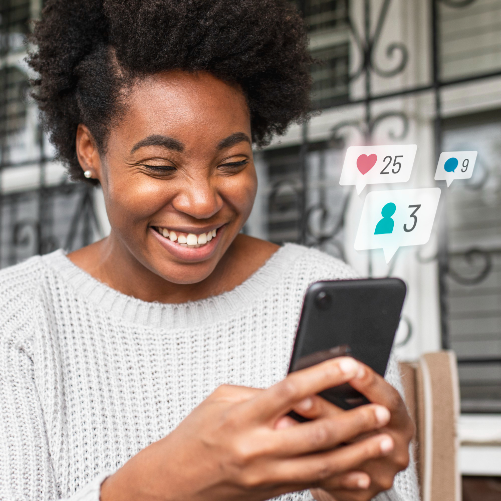 Woman smiling while receiving social media notifications on her smartphone